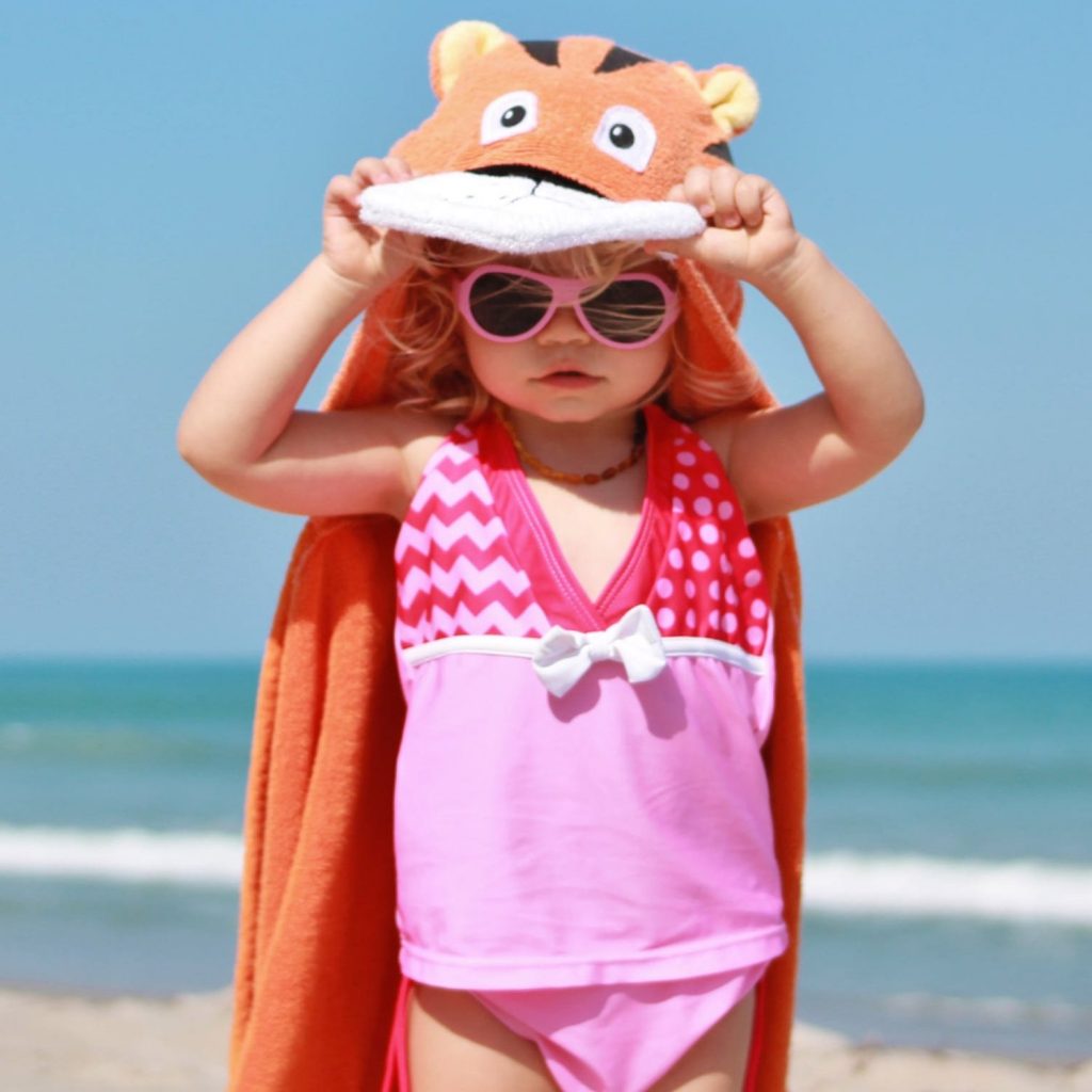 A child just being cool, hanging out with their beach hooded towel