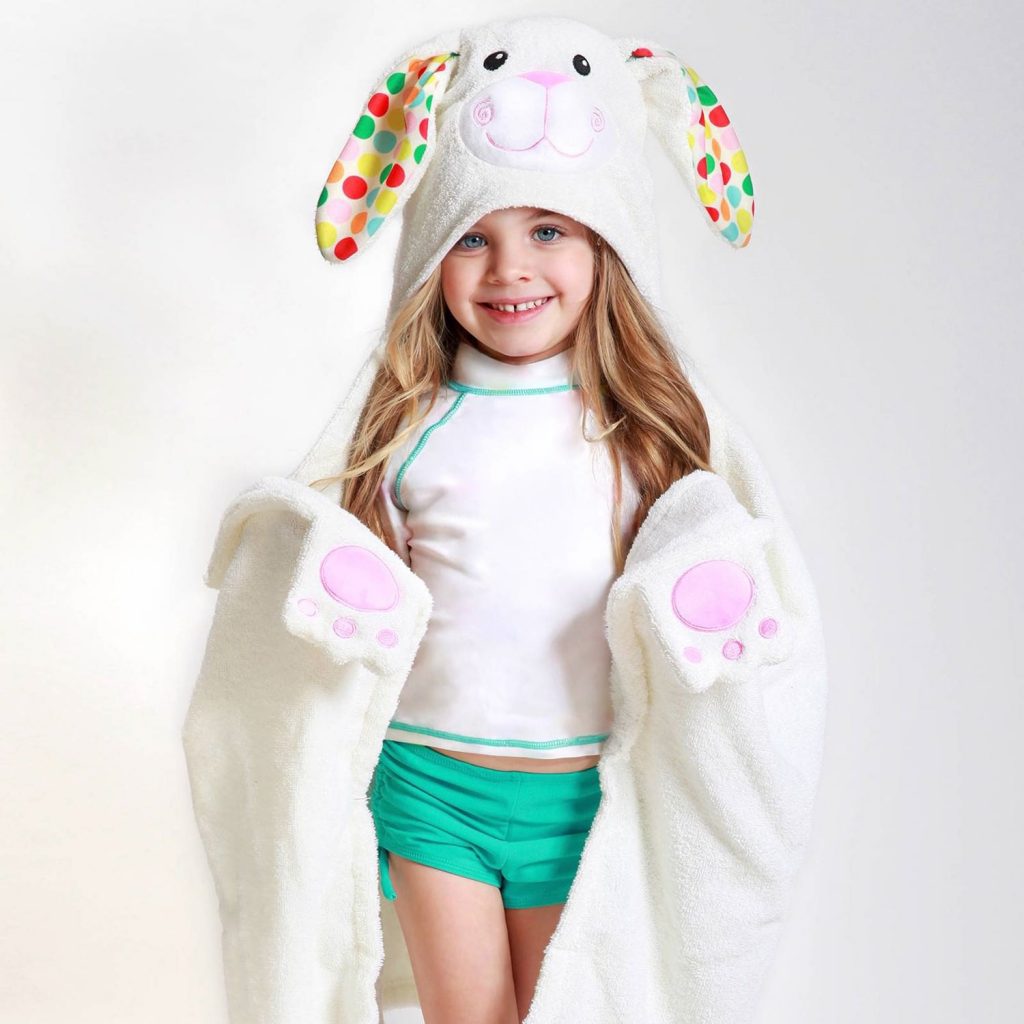 A kid wearing the adorable bunny hooded towel by Zoocchini